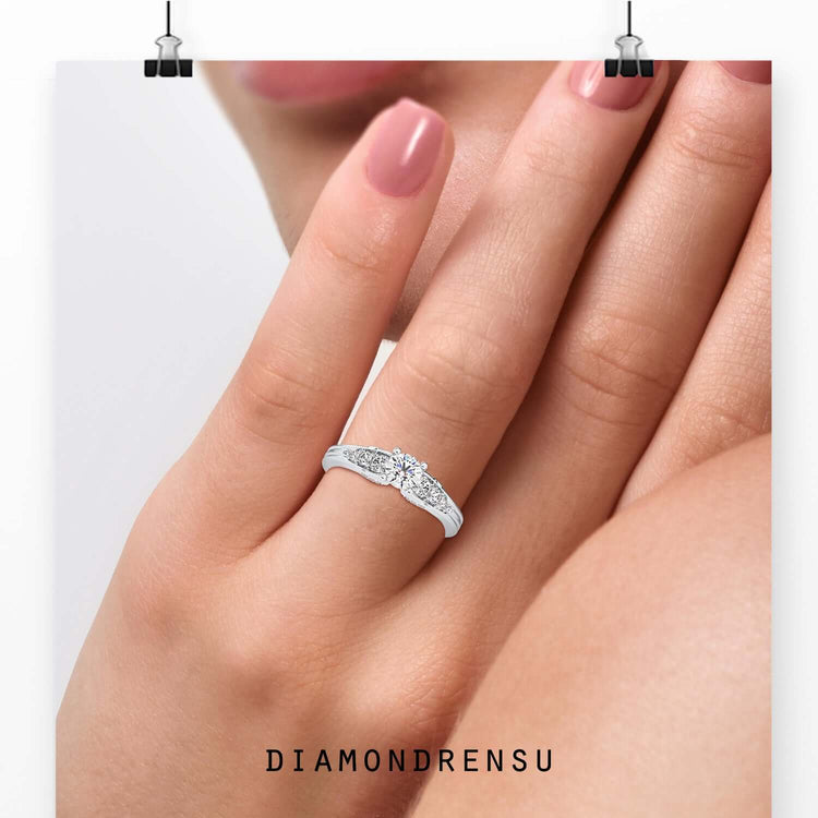 Brilliant cut diamond ring featuring round side stones and a four prong 
setting