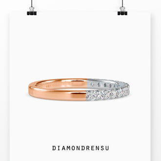 Brilliant cut diamond wedding band in yellow gold with prong settings.
