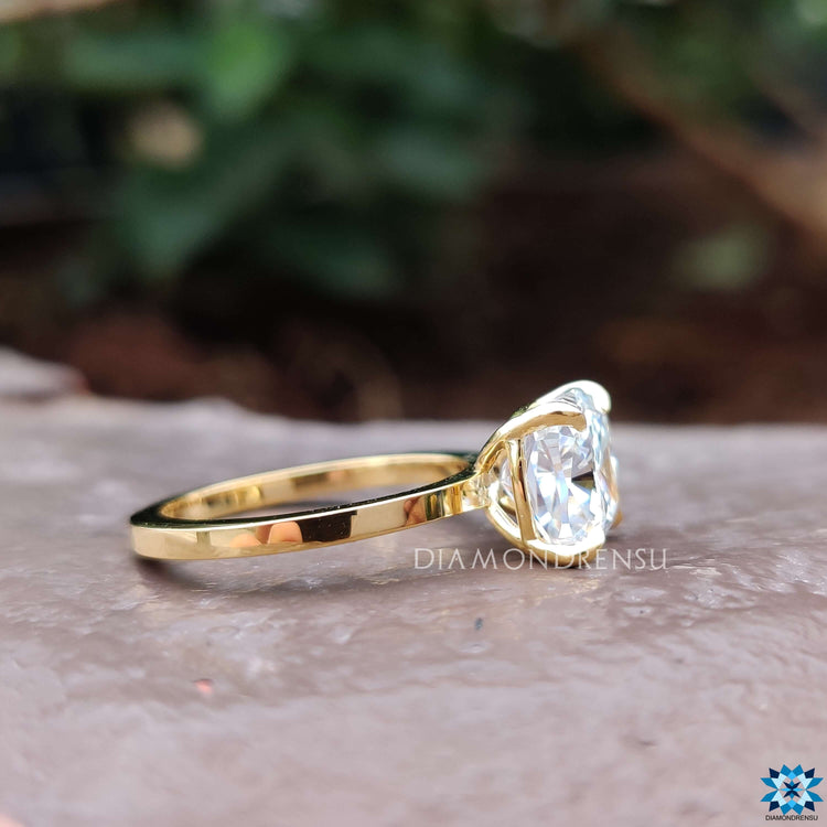A gold solitaire engagement ring with a luxurious and radiant yellow gold finish.