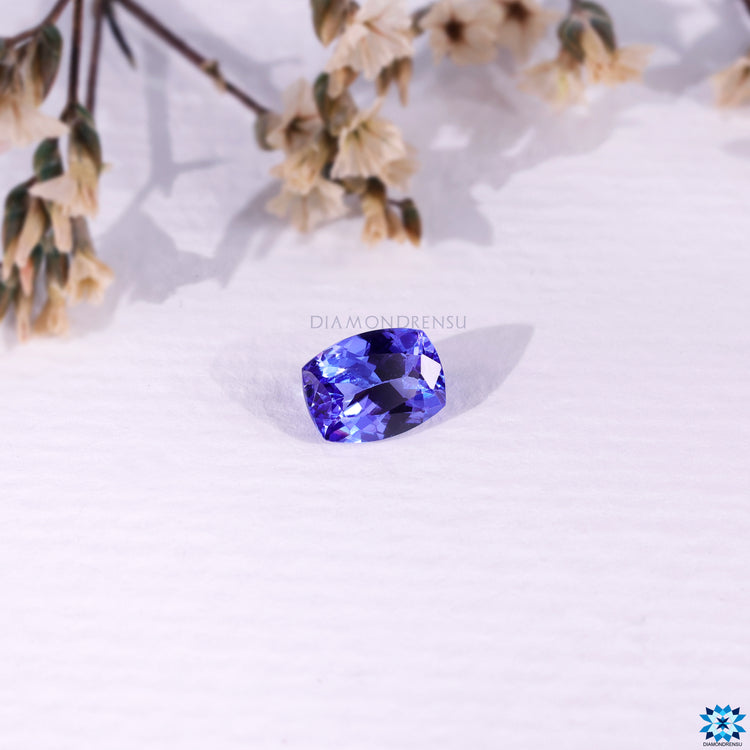 Natural tanzanite gems shown as a 1.54 carat cushion cut stone, perfect for December birth stones display.
