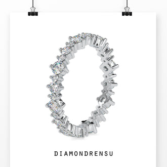 White gold wedding band featuring a full eternity band with round diamonds.
