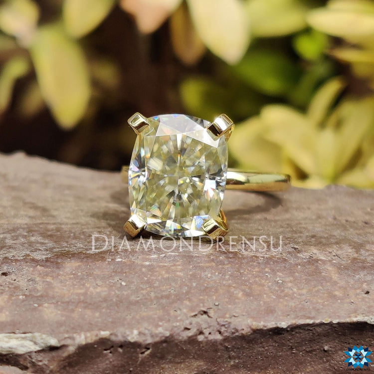Cushion cut moissanite solitaire ring with a radiant centre stone.
