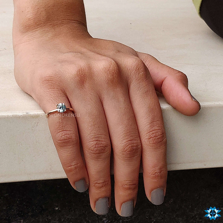 Exquisite diamondrensu ring with a bold moissanite round cut.