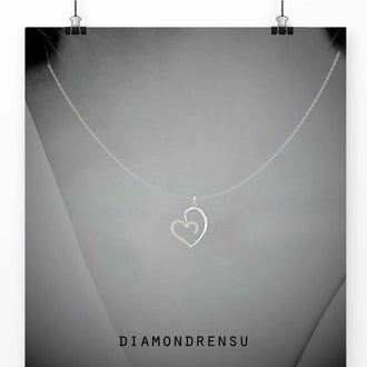 Diamond heart pendants with a shared prong setting, a stunning handmade jewelry piece.
