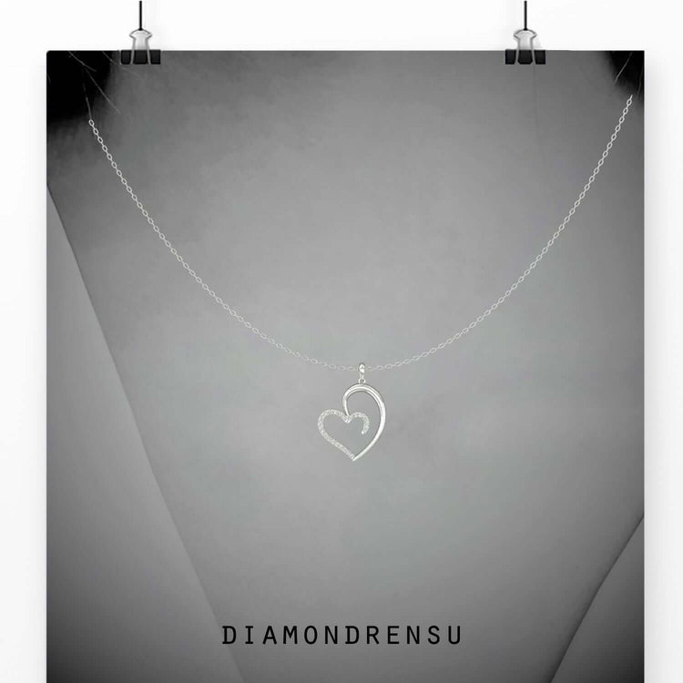 Diamond heart pendants with a shared prong setting, a stunning handmade jewelry piece.
