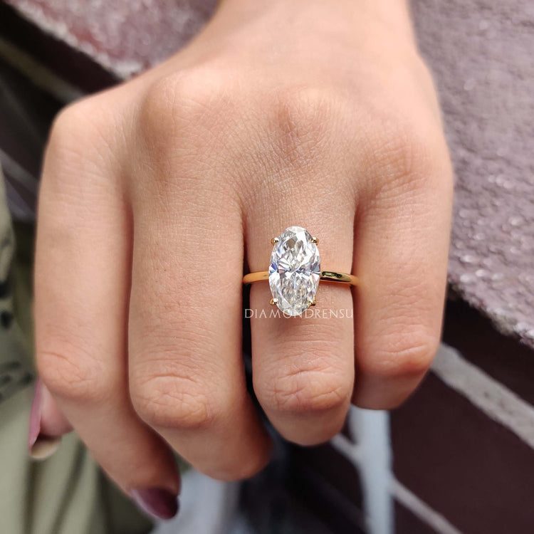 Unique moval engagement ring with a sparkling moissanite centre stone.
