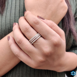 Trio wedding band featuring round moissanite gemstones.