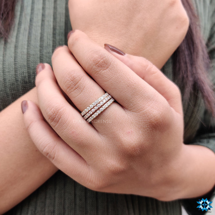 Trio wedding band featuring round moissanite gemstones.